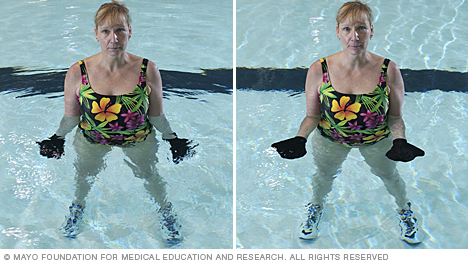 Woman doing arm exercise using hand webs