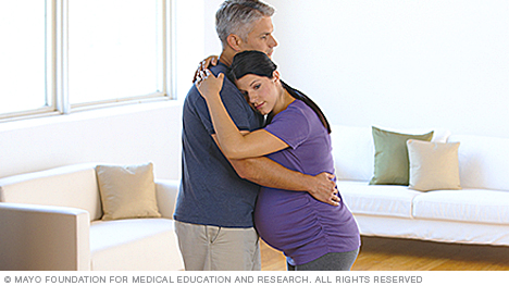 A person in labor swaying with partner