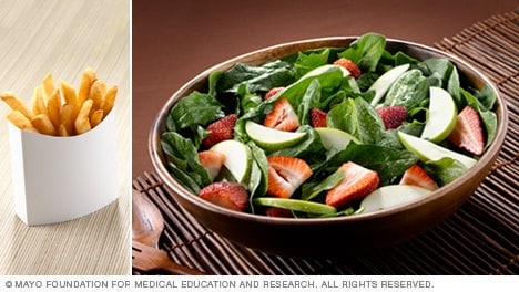 Comparación de papas fritas con espinaca y ensalada de frutas