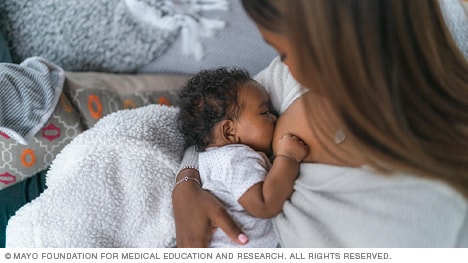 Woman breastfeeding with cradle hold