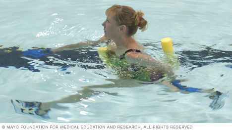 Woman deep-water walking with hand webs