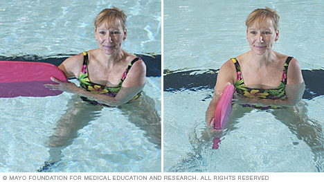 Woman doing resistance exercise using a kickboard