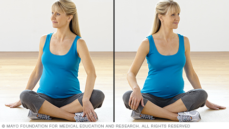 Pregnant person doing torso rotation