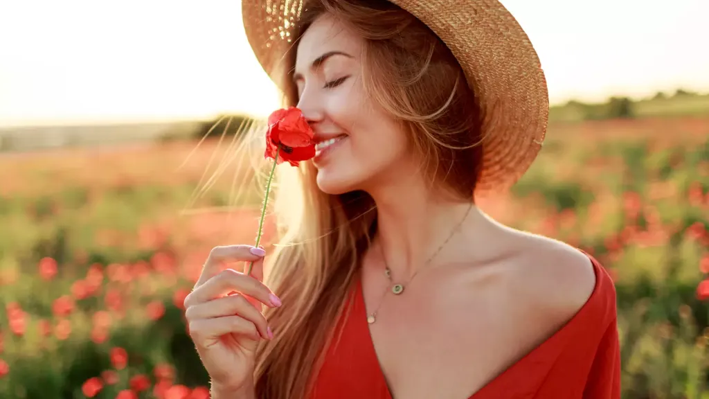 happy woman in beautiful red dress with rose