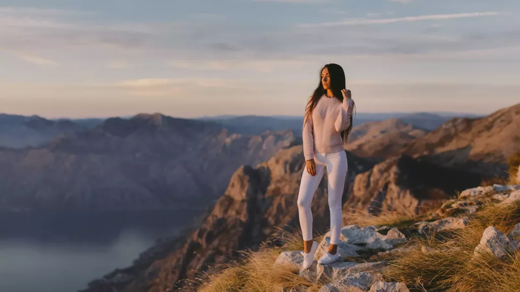 woman on montain top river