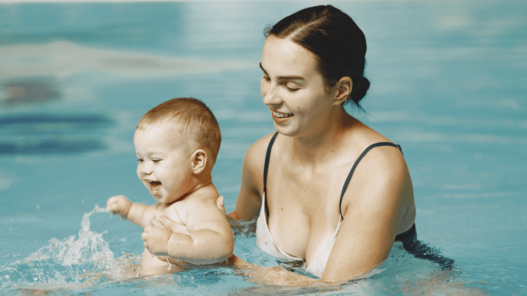 baby with mom in pool