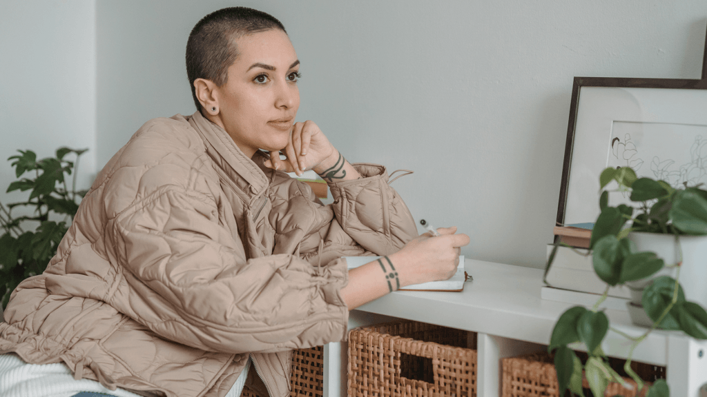 woman thinking and writing