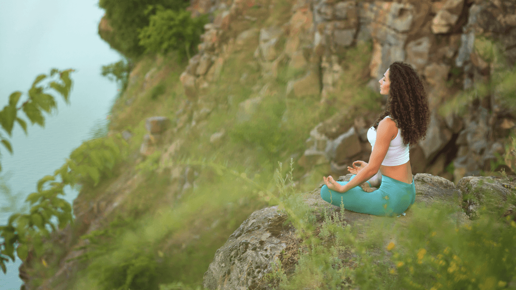 woman meditating mountains