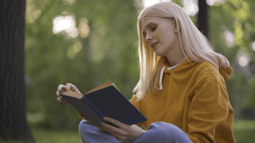 woman reading book in jungle