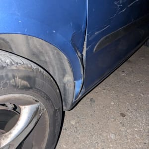 נזק לפח רכב כחול עם שריטות ועיקום