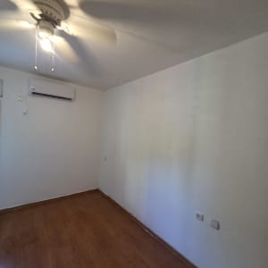 חדר ריק עם קיר צבוע ומאוורר תקרה