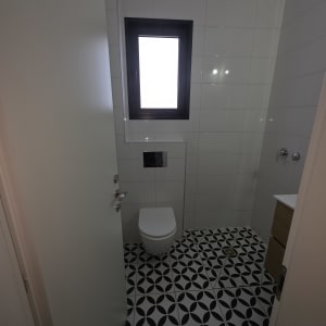 חדר שירותים עם חלון ודלת פתוחה