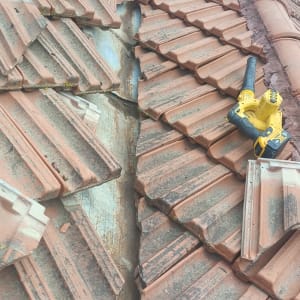 תמונה של גג רעפים עם כלי עבודה צהוב מונח עליו