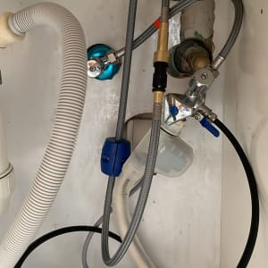 צינורות מים מתחת לכיור עם ברזים וחיבורים