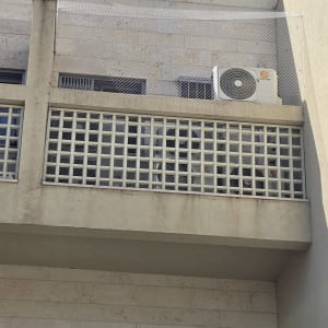 התקנת רשת ודוקרנים להרחקת יונים במסתור כביסה בבניין מגורים