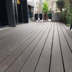 דק עץ חום עם צמחייה מסביב