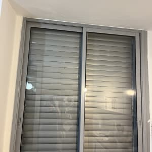 חלון עם תריסים סגורים בחדר פנימי