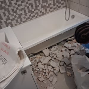 חדר אמבטיה בשיפוץ עם אריחים שבורים על הרצפה