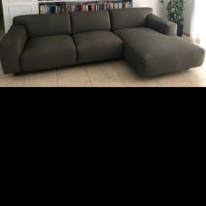 ספה מרופדת בצבע כהה עם כריות ישיבה