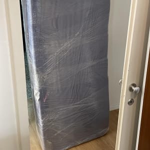 מזרן עטוף בניילון עומד בדלת