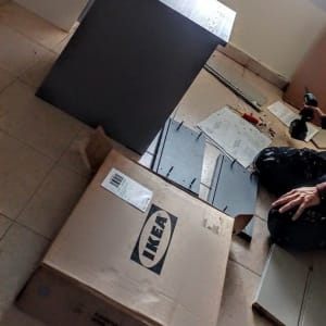 אדם מרכיב רהיט עם כלי עבודה וחלקים מאיקאה