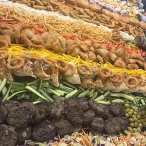 שולחן שוק בשרי עמוס בקציצות בשר, המבורגרים, מטוגנים וסלטים