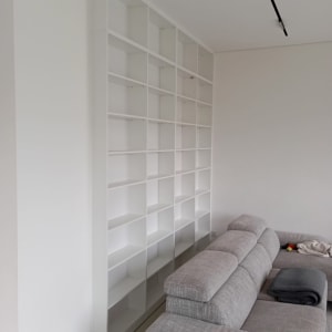 מדפי עץ לבנים מותקנים על קיר לבן