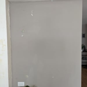 קיר צבוע בגוון אפור עם סימני תיקון צבע