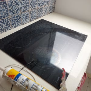 אקדח סיליקון על משטח ליד כיריים