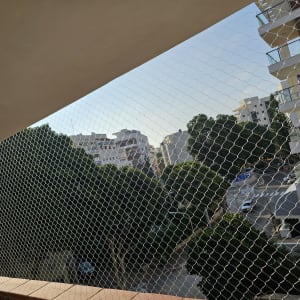 רשת מתכת מותקנת למניעת כניסת יונים למרפסת