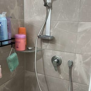 ראש מקלחת עם צינור ומדף קטן