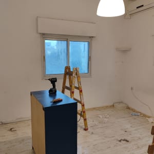 סולם, מקדחה ומברג על ארון בחדר