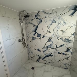 חדר אמבטיה עם אריחים מעוצבים ומקלחת