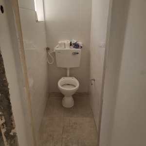 שירותים עם קירות חשופים, אריחים חדשים על הרצפה