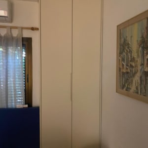 ארון בגדים לבן עם דלתות סגורות בחדר