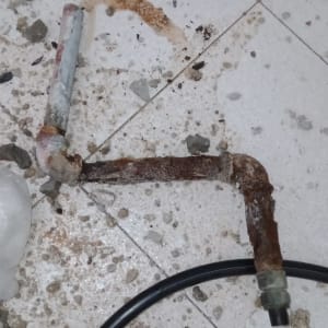 צינור חלוד על רצפה עם לכלוך