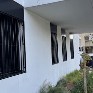 חלונות עם סורגים שחורים על קיר לבן