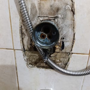 פירוק כיסוי ברז אינטרפוץ בקיר חדר רחצה לצורך תיקון או החלפה