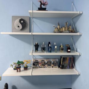 מדפים מותקנים עם פריטים דקורטיביים, כולל פסנתר חשמלי.