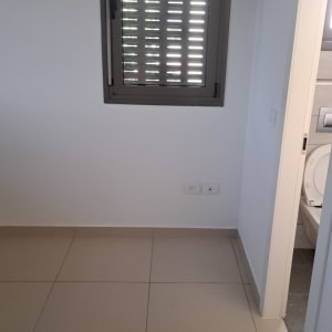 חדר מבריק ונקי בדירה ריקה לאחר ניקוי יסודי של הריצוף והחלונות