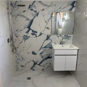 חדר אמבטיה משופץ עם אריחים מעוצבים ומקלחת