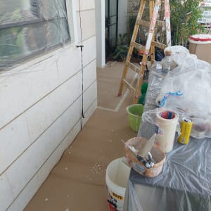 סולם, דלי צבע וכלי עבודה לצביעה במרפסת