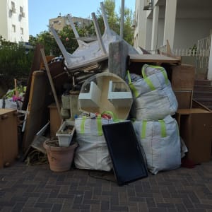 ערימת רהיטים ופסולת ליד בניין מגורים