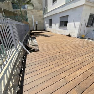 בניית דק עץ גדול בחצר בית פרטי