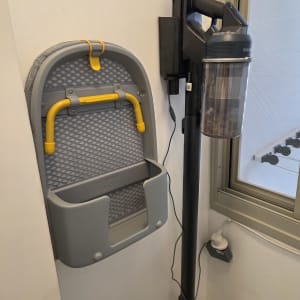 שואב אבק תלוי על הקיר ליד קרש גיהוץ