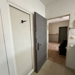 דלת פתוחה עם ידית מתכת בחדר כניסה