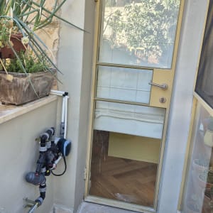 מערכת השקיה ליד דלת זכוכית עם צמחים