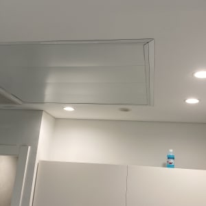 תקרת גבס עם תאורה שקועה ובקבוק על ארון