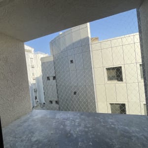 רשת יונים מותקנת על חלון בניין למניעת כניסת יונים