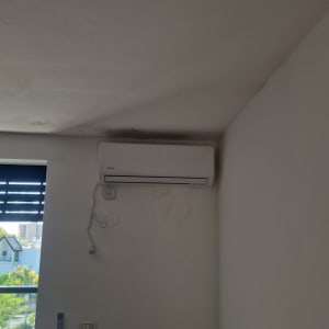 מזגן מותקן על קיר בחדר עם חלון